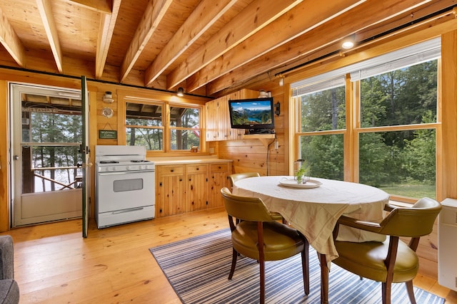 660 Sprague Rd, Waldoboro, ME 04572 - dining area with light wood-style flooring, wood walls, and a wood ceiling with exposed beams