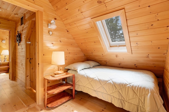 660 Sprague Rd, Waldoboro, ME 04572 - bedroom featuring wood walls, hardwood / wood-style flooring, wooden ceiling, a skylight, and lofted ceiling