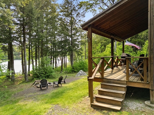 660 Sprague Rd, Waldoboro, ME 04572 - view of green lawn with a deck with water view and a fire pit
