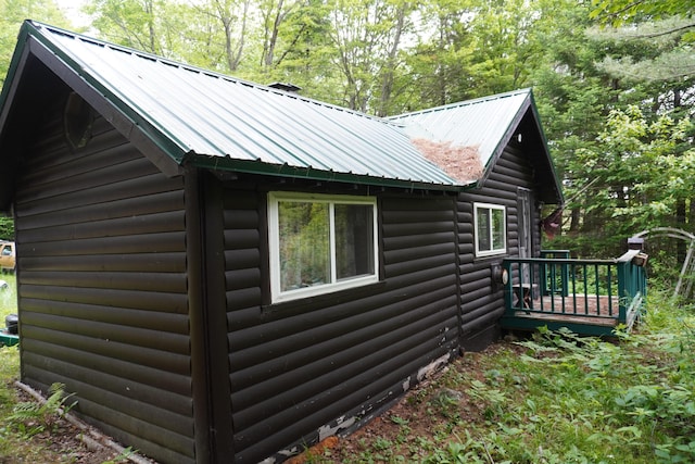 866 School St, Perkins Twp, ME 04294 - view of side of home featuring log veneer siding, a metal roof, and a wooden deck
