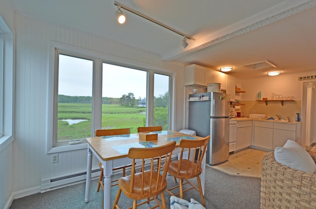 5 Dyke Rd Unit G, Kennebunkport, ME 04046 - dining area featuring a baseboard heating unit, rail lighting, and light colored carpet