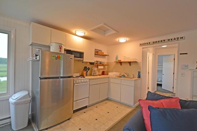 5 Dyke Rd Unit G, Kennebunkport, ME 04046 - kitchen featuring appliances with stainless steel finishes, white cabinets, open shelves, light countertops, and open floor plan