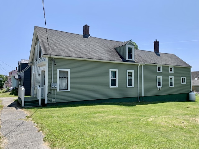 14 Third St, Eastport, ME 04631 - view of side of home featuring a chimney and a lawn