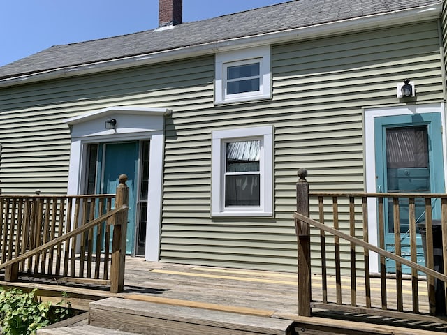 14 Third St, Eastport, ME 04631 - entrance to property featuring a wooden deck, a chimney, and a shingled roof
