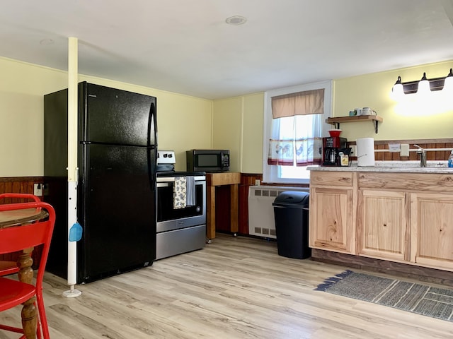 14 Third St, Eastport, ME 04631 - kitchen with black appliances, light wood-style flooring, light brown cabinetry, and open shelves