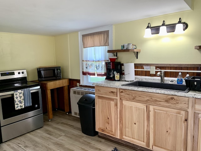 14 Third St, Eastport, ME 04631 - kitchen featuring electric range, radiator, light wood finished floors, light brown cabinets, and open shelves