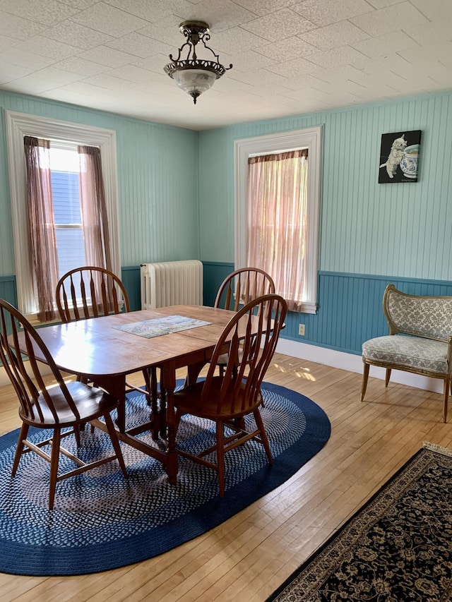 14 Third St, Eastport, ME 04631 - dining room featuring radiator heating unit and hardwood / wood-style floors