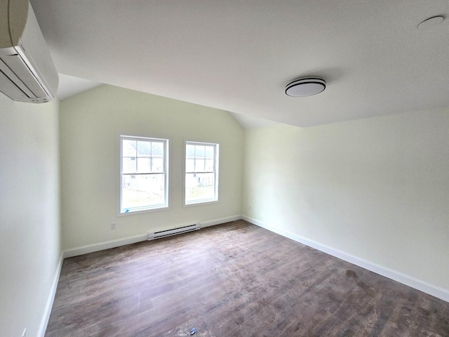 17 Signal St Unit I-1, Sanford, ME 04083 - bonus room featuring a wall unit AC, dark wood-style floors, a baseboard heating unit, and vaulted ceiling
