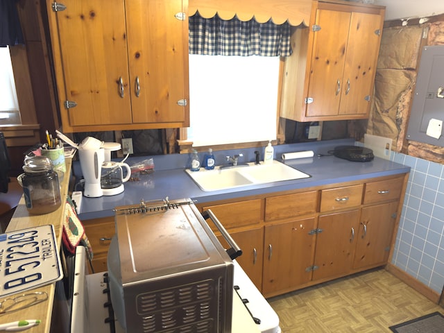 107 Haskell Ave, Raymond, ME 04071 - kitchen with tile walls, electric panel, and brown cabinets