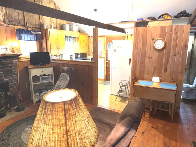 107 Haskell Ave, Raymond, ME 04071 - living room featuring a wood stove, lofted ceiling, and wood finished floors