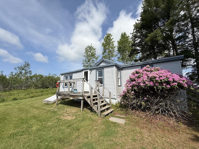 152 Kansas Rd, Milbridge, ME 04658 - rear view of property with a yard and a wooden deck