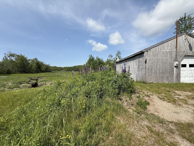 152 Kansas Rd, Milbridge, ME 04658 - view of yard featuring a garage, an outdoor structure, and driveway