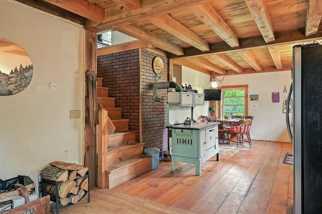208 Benson Rd, West Gardiner, ME 04345 - kitchen with freestanding refrigerator, light wood-style flooring, and a wooden ceiling with exposed beams