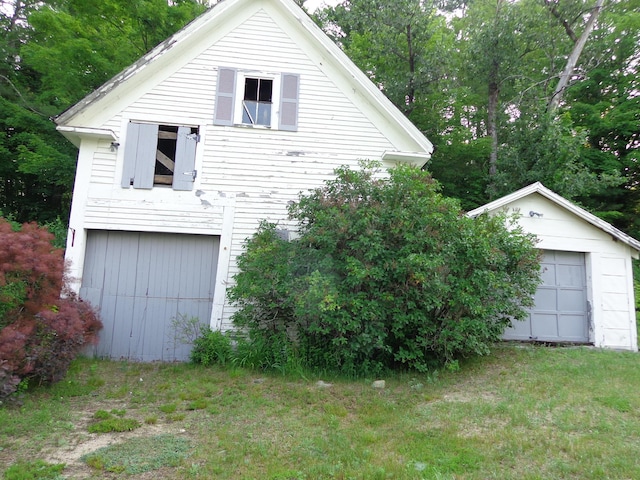 59 Main St, Shapleigh, ME 04076 - view of side of home with an outbuilding, a lawn, and a garage