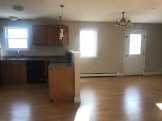 406 Cumberland St, Westbrook, ME 04092 - kitchen with baseboard heating, dishwasher, wood finished floors, dark countertops, and a chandelier