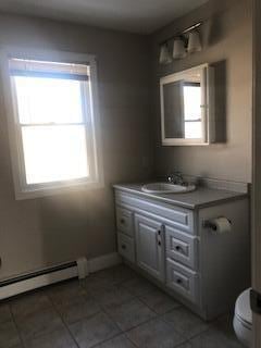406 Cumberland St, Westbrook, ME 04092 - bathroom featuring vanity, tile patterned floors, and baseboard heating