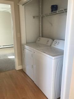 406 Cumberland St, Westbrook, ME 04092 - laundry room with separate washer and dryer, light wood-type flooring, and a baseboard heating unit