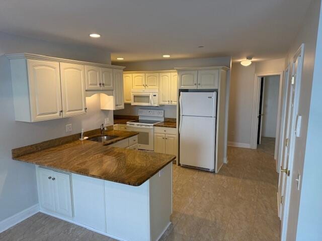 345 Saco St Unit 40, Westbrook, ME 04092 - kitchen with white appliances, a peninsula, dark countertops, recessed lighting, and white cabinetry