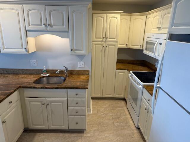 345 Saco St Unit 40, Westbrook, ME 04092 - kitchen with white appliances, dark countertops, and white cabinets