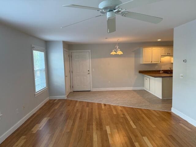 345 Saco St Unit 40, Westbrook, ME 04092 - unfurnished living room with wood finished floors, ceiling fan, and a chandelier