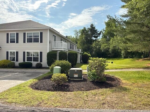 345 Saco St Unit 40, Westbrook, ME 04092 - view of side of home with a yard, a balcony, and uncovered parking