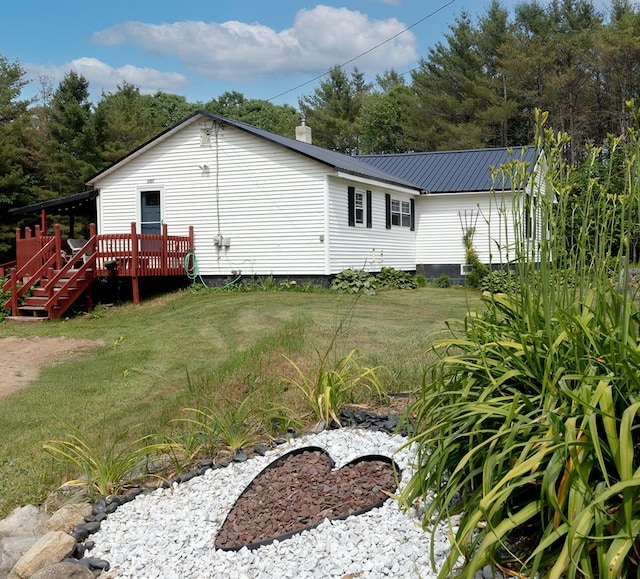 2857 Ohio St, Glenburn, ME 04401 - view of home's exterior with a deck, a yard, a metal roof, and stairs
