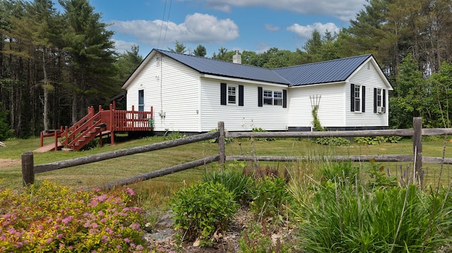 2857 Ohio St, Glenburn, ME 04401 - view of side of home with a metal roof, a lawn, a deck, and stairs