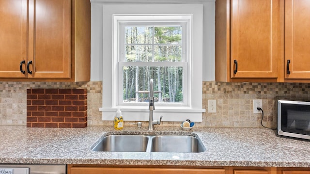 2857 Ohio St, Glenburn, ME 04401 - kitchen featuring stainless steel microwave, light stone counters, and tasteful backsplash
