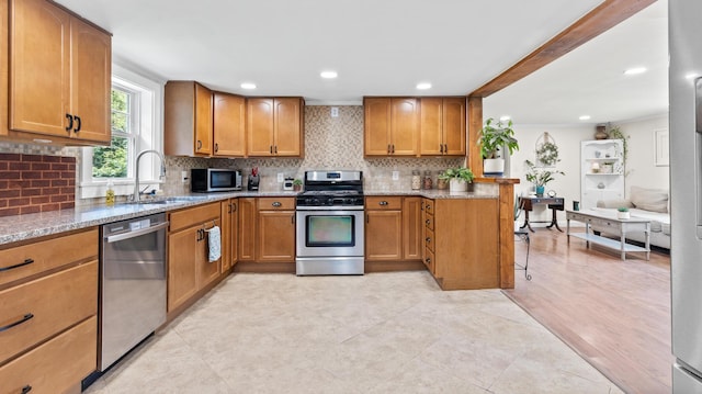 2857 Ohio St, Glenburn, ME 04401 - kitchen featuring stainless steel appliances, light stone countertops, brown cabinetry, backsplash, and recessed lighting