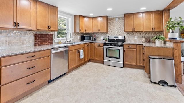2857 Ohio St, Glenburn, ME 04401 - kitchen featuring appliances with stainless steel finishes, light stone countertops, decorative backsplash, brown cabinets, and recessed lighting