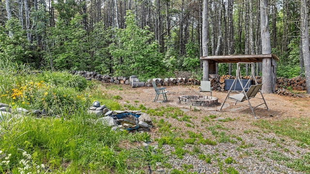 2857 Ohio St, Glenburn, ME 04401 - view of yard with a fire pit and a forest view