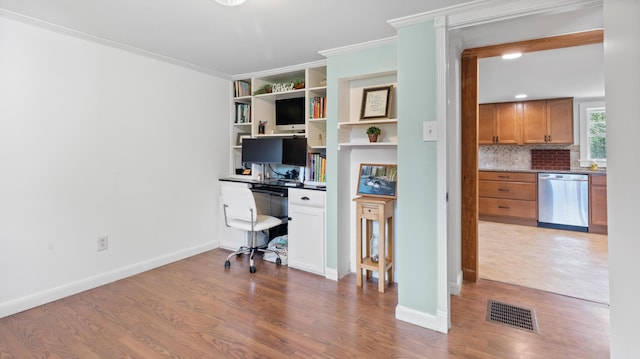 2857 Ohio St, Glenburn, ME 04401 - unfurnished office with built in desk, wood finished floors, and ornamental molding