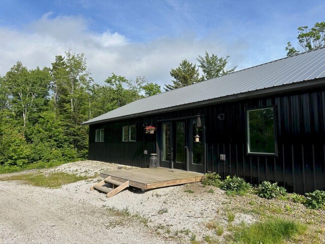 599 Mile Square Rd, Avon, ME 04966 - view of front facade with a metal roof and french doors