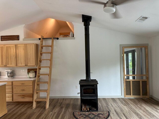 599 Mile Square Rd, Avon, ME 04966 - unfurnished living room with lofted ceiling, a wood stove, dark wood-style floors, and a ceiling fan
