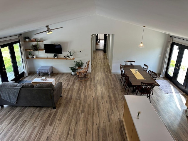 599 Mile Square Rd, Avon, ME 04966 - living area with french doors, plenty of natural light, vaulted ceiling, and wood finished floors