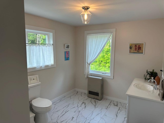 599 Mile Square Rd, Avon, ME 04966 - bathroom with heating unit, vanity, and marble look tiles