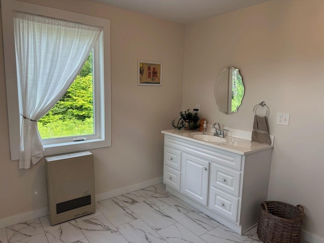 599 Mile Square Rd, Avon, ME 04966 - bathroom featuring heating unit, marble look tiles, and vanity