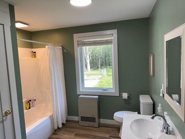 599 Mile Square Rd, Avon, ME 04966 - bathroom with heating unit, wood finished floors, and shower / bathtub combination with curtain