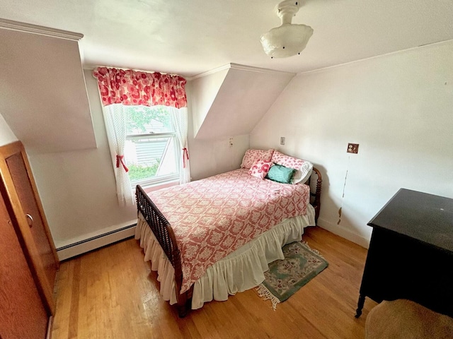 41 York St, Millinocket, ME 04462 - bedroom with a baseboard heating unit, wood finished floors, lofted ceiling, and crown molding