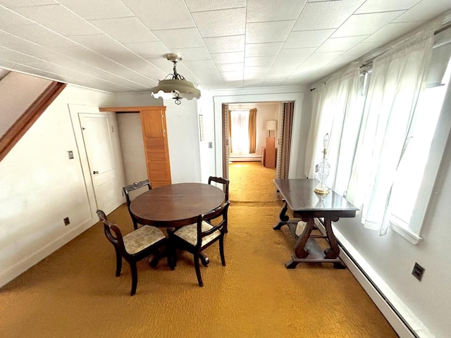 41 York St, Millinocket, ME 04462 - dining area with baseboard heating, healthy amount of natural light, and light colored carpet