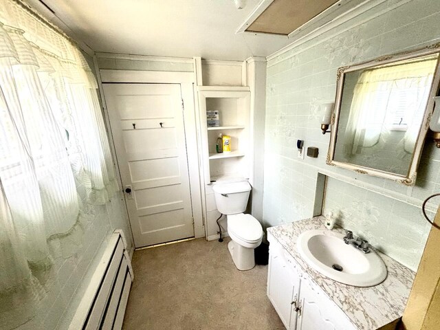 41 York St, Millinocket, ME 04462 - bathroom with vanity, baseboard heating, and backsplash