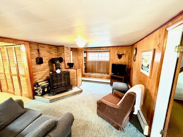 41 York St, Millinocket, ME 04462 - living room with a wood stove, a baseboard heating unit, wooden walls, and carpet