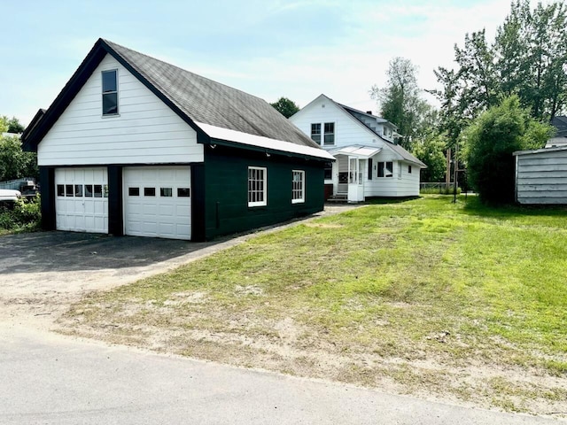 41 York St, Millinocket, ME 04462 - view of side of home featuring a lawn, an outbuilding, and a detached garage