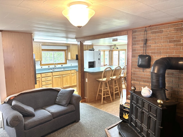 41 York St, Millinocket, ME 04462 - living room with light wood finished floors and brick wall