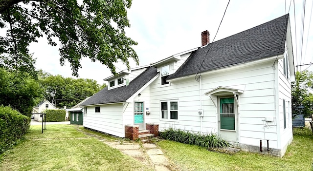 41 York St, Millinocket, ME 04462 - rear view of property featuring a shingled roof, a chimney, a yard, and entry steps