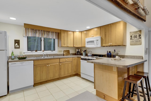 86 Sandy Cove Rd, Standish, ME 04084 - kitchen with white appliances, a peninsula, a kitchen bar, recessed lighting, and light tile patterned floors
