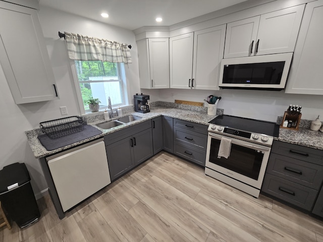 1083 N Rd, Newburgh, ME 04444 - kitchen featuring stainless steel electric range oven, white microwave, dishwasher, gray cabinets, and light stone counters
