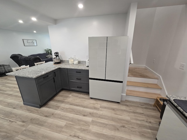 1083 N Rd, Newburgh, ME 04444 - kitchen with freestanding refrigerator, gray cabinetry, light stone countertops, a peninsula, and recessed lighting