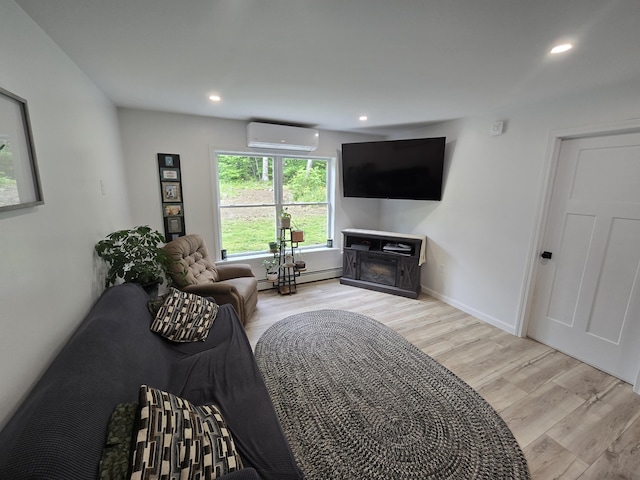 1083 N Rd, Newburgh, ME 04444 - living room with a wall unit AC, light wood finished floors, recessed lighting, a baseboard radiator, and a fireplace