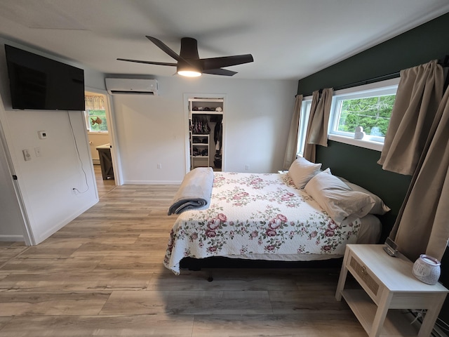 1083 N Rd, Newburgh, ME 04444 - bedroom featuring a wall mounted air conditioner, light wood-style flooring, ceiling fan, and a spacious closet